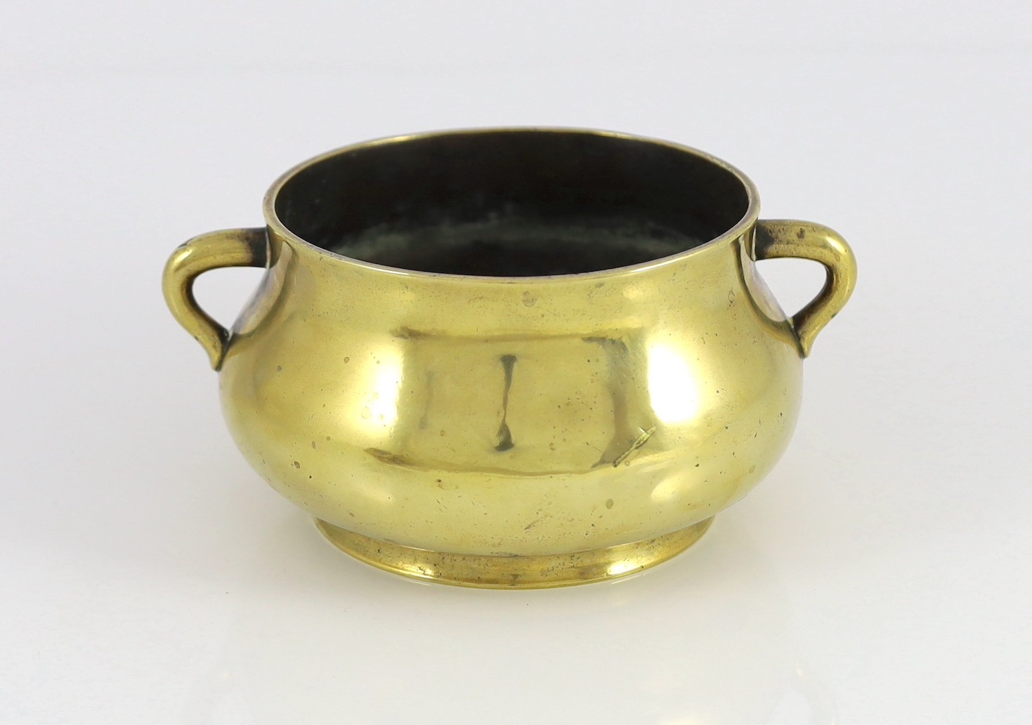 A Chinese polished bronze censer, gui, Xuande six character mark, 18th/19th century, 19cm wide, dented, solder repair